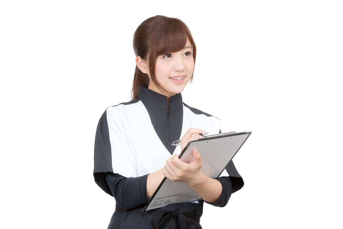 クリップボードを持って笑顔のスタッフ